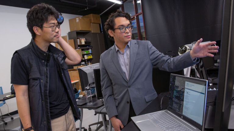 Computer science major Benjamin Joseph L. Herrera (left) is developing VivyNet, a tool that lets anyone create music from poems with artificial intelligence, with Assistant Professor Yezhou Yang (left).