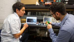 Electrical engineering junior Humberto Delgado (left) works with Mike Ranjram (right), an assistant professor of electrical engineering, on a FURI project to miniaturize power electronics to make data centers more energy-efficient.