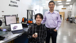 Zhengbin Chen (left), a senior engineering major focusing on the robotics concentration, works on an additive manufacturing model with his faculty mentor, Andi Wang, an assistant professor of manufacturing engineering.