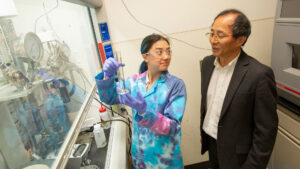 Chemical engineering major Kelly Nguyen and Professor Shuguang Deng in a research lab.