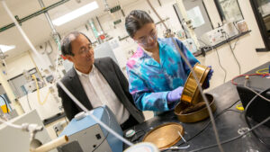 Professor Shuguang Deng and chemical engineering major Kelly Nguyen in a research lab.