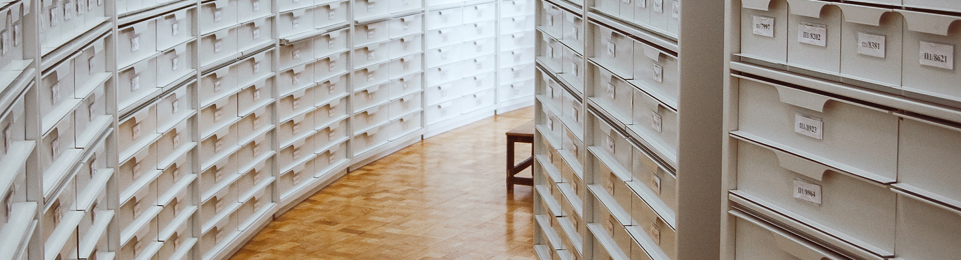A tidy file room, gracefully curving to the right. Photo by Ula Kuźma on Unsplash.