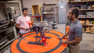 Civil engineering major Othman Al-Alawi (right) works with another student in Hasan Ozer's lab on a FURI research project to harness drones with thermal cameras to help evaluate sustainable pavement treatments' impact on heat islands.