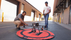 Civil engineering major Othman Al-Alawi (left) works with another student in Hasan Ozer's lab on a FURI research project to harness drones with thermal cameras to help evaluate sustainable pavement treatments' impact on heat islands.