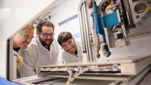 Electrical engineering major Jacob Burrows (center), pictured with student Hunter Mantle (left) and faculty mentor Nicholas Rolston (right) works on a FURI research project to improve semiconductor performance and longevity.