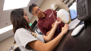 Biomedical engineering major Ava Claire Lariego (left) works with faculty mentor SungMin Sohn on a FURI research project to develop a new material to improve magnetic resonance imaging.