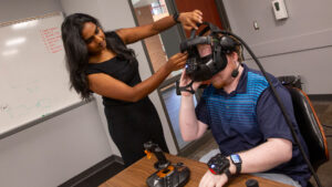 Computer science major Neha Balamurugan (left) works with student Andrew Miller in the Dreamscape Learn facilities on a FURI project to use virtual reality for better data visualization.