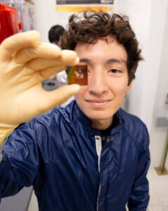 An ASU FURI student holds up a specimen.