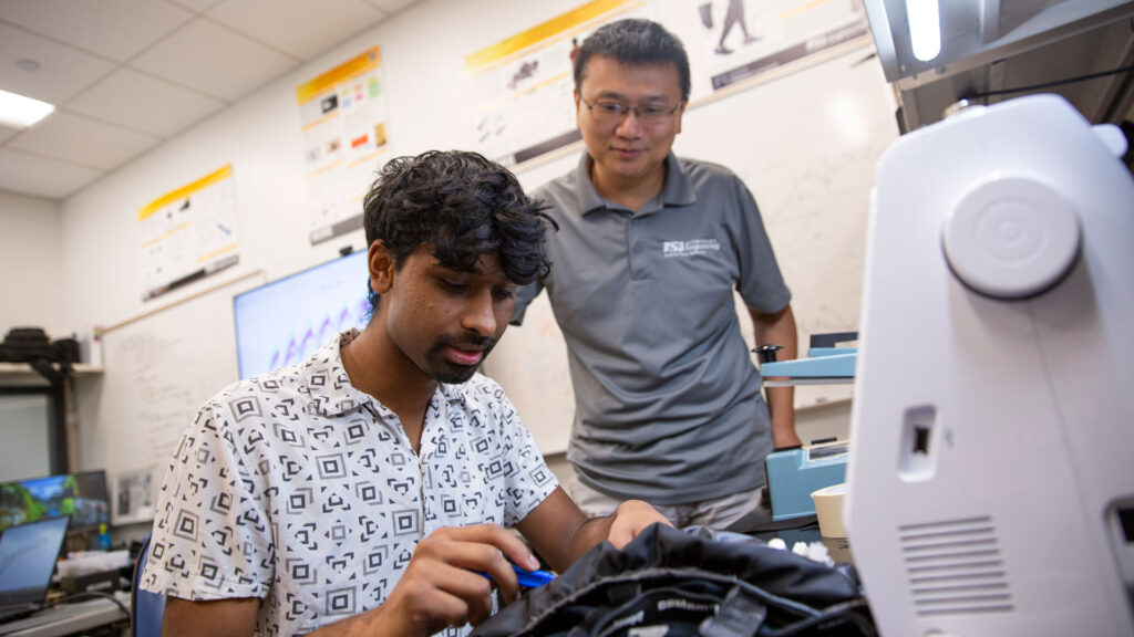 An ASU FURI student works in the lab with his mentor.