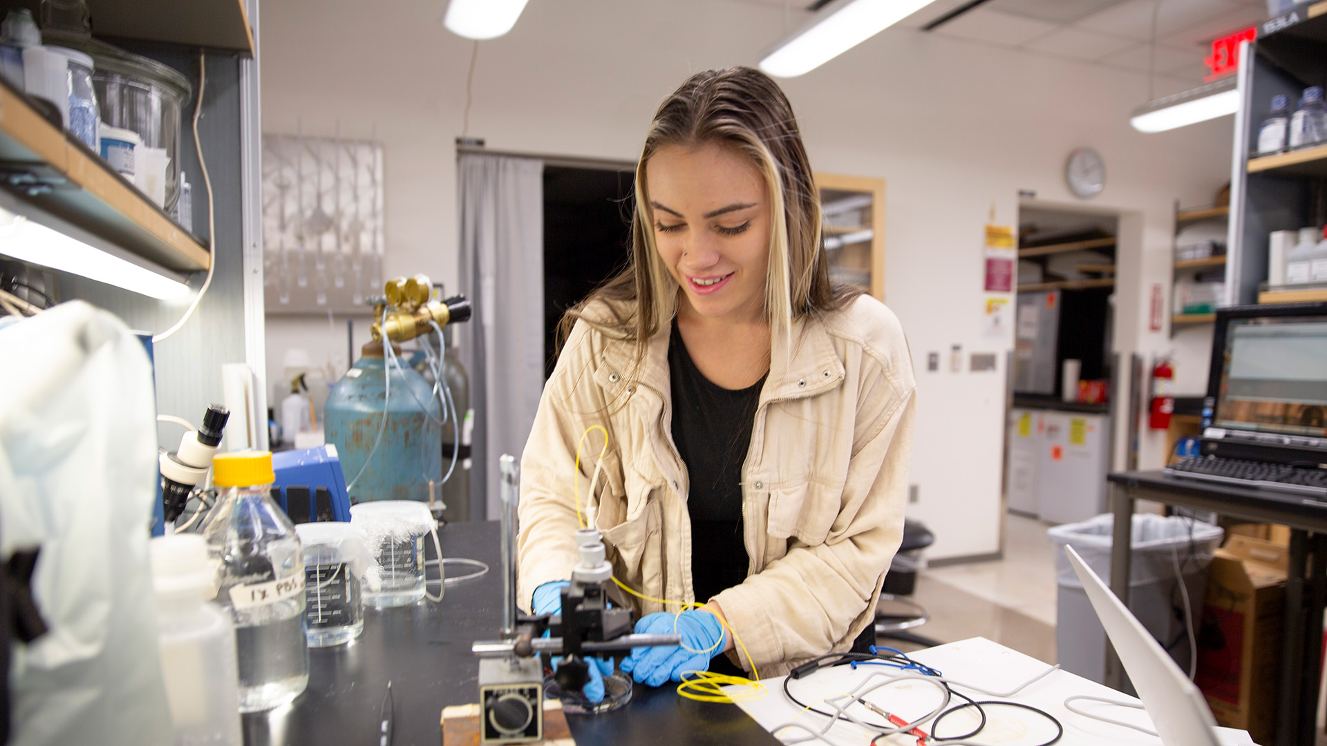 Camila De Barros Leandro works with equipment in a lab