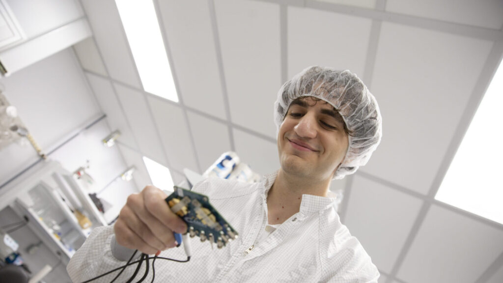 Zeyad George looks at a semiconductor device