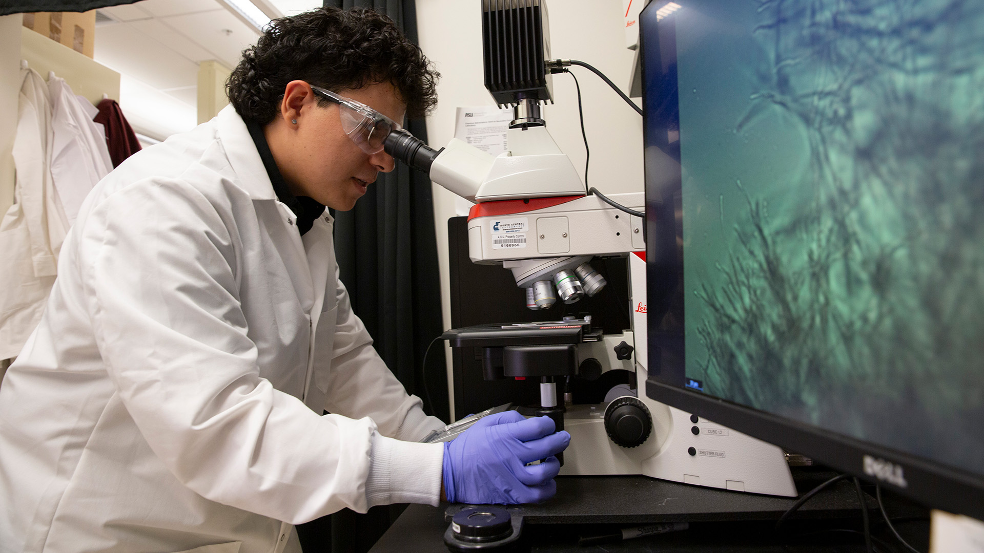 Diego Sanchez works with equipment in a lab.